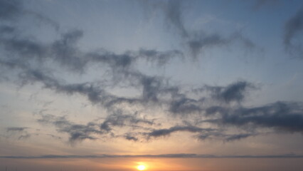 Fototapeta premium Dramatic Sunset Sky with Layered Clouds
