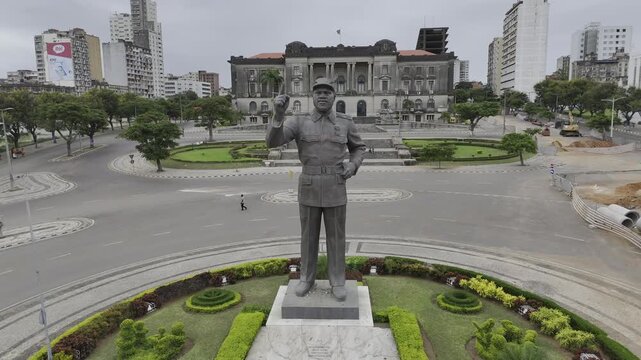 Drone slowly flies toward Samora Machel statue at Independence Square on an overcast day in Maputo, Mozambique