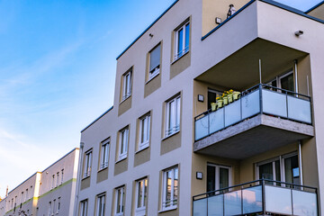 Obraz premium fragments modern multi-storey residential buildings European city, high-rise apartments, urban architecture, Contemporary residential design integrates private outdoor space, high-density environments