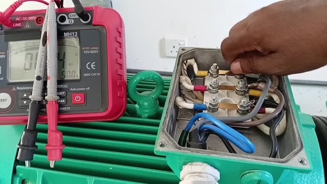 Motor Testing Sequence: Electrician Reconnecting Power Cables and Terminal Links After Successful Motor Testing