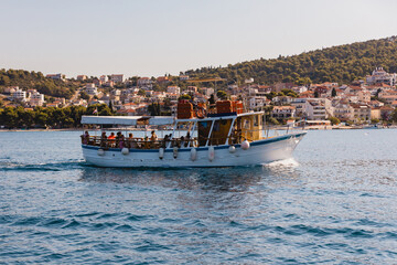 Obraz premium Traditional wooden tourist excursion boat cruising in the Adriatic Sea
