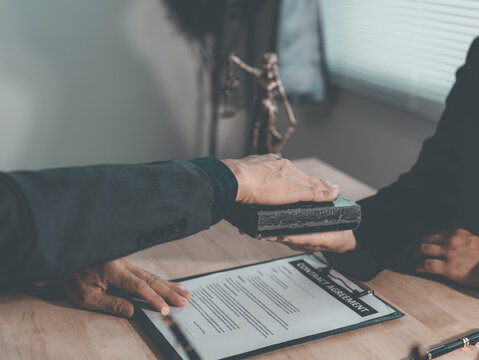 The lawyer advised his client on contractual documents, using a brass scale to explain legal points in court.