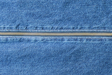 Denim zipper repair. Closeup of denim with zipper. Tailor repairing denim pocket under studio lighting. Indigo denim fabric with brass hardware and textured weave details © Маргарита Трушина