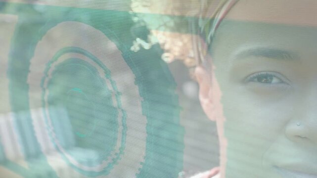 Woman shifting to smile while green-blue bands sweeping, showing face, rings, bench aiding design