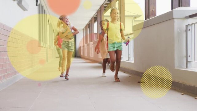 Four girls running down hall, motion from distance initiating color circles over bags for education