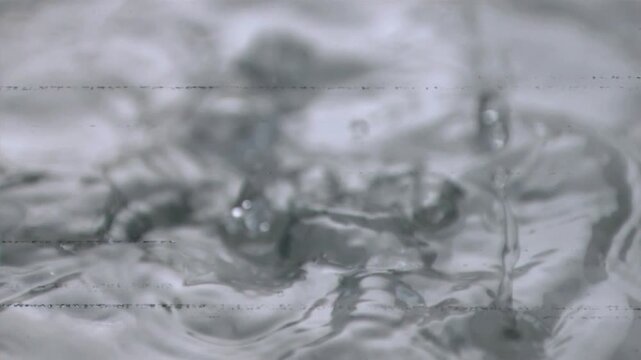 Glitch bars popping, masking water, drops striking, forming ripples and bubbles, showing glitch