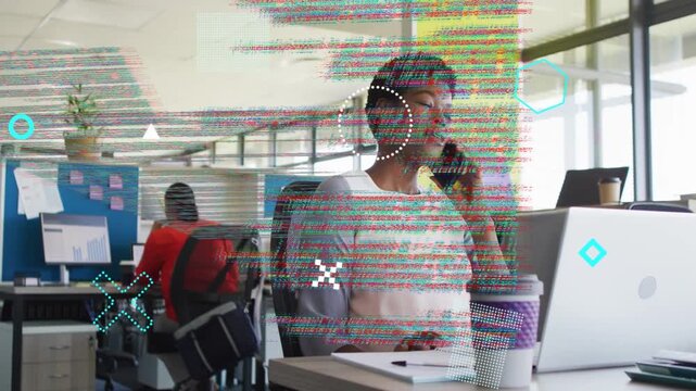 Businesswoman taking phone while typing on laptop and causing code overlay over frame for project