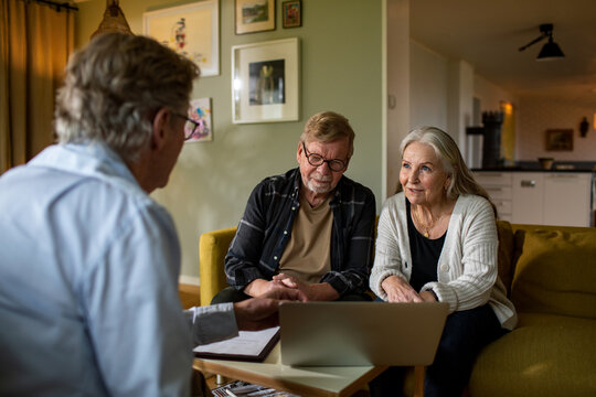 Senior couple meeting financial advisor at home