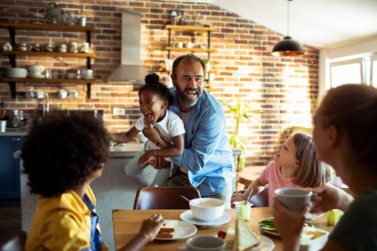 Playful family breakfast in cozy home kitchen