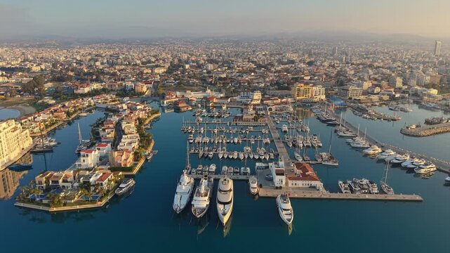 Impressive aerial view of luxury Limassol Marina featuring expensive yachts and private villas. Residential area of Limassol Marina with stunning swimming pools, elegant boats, Cyprus
