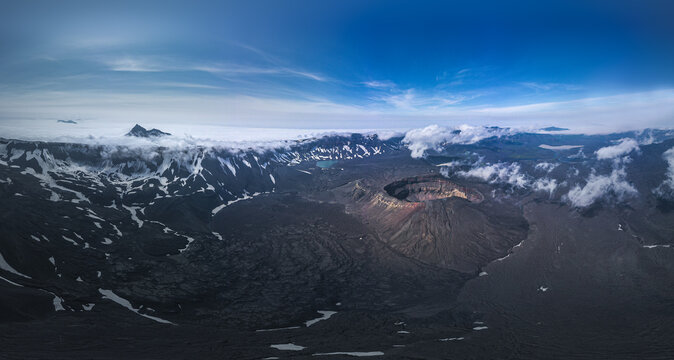 Aerial view of Okmok Volcano caldera with crater lake and glacial snow, Umnak Island, Alaska