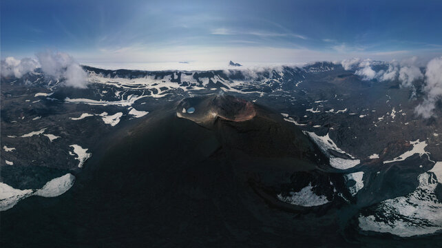 Aerial view of Okmok Volcano caldera with crater lake and glacial snow, Umnak Island, Alaska