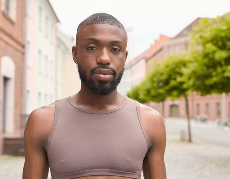 A confident portrait of a transgender Somali woman in northern Europe Scandinavia showing her pride and identity on an urban city street.