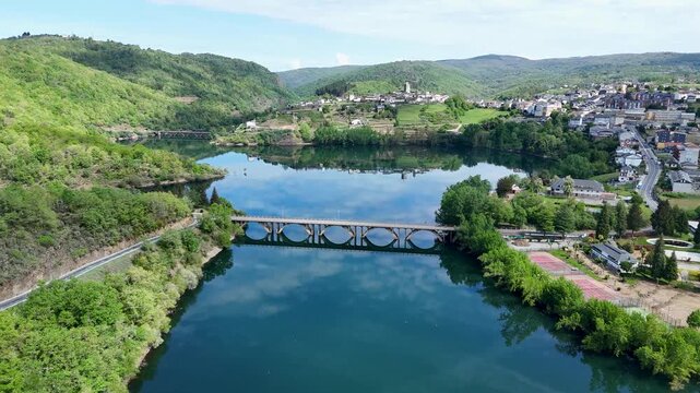 Aerial view flying over viana do bolo town and bao reservoir