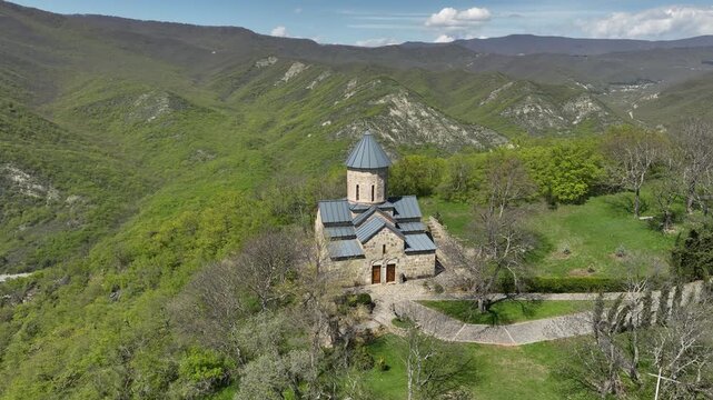 Aerial shot of the Mamkoda Monastery, located near Tbilisi. The image captures the historic stone architecture of the church and its surrounding monastic buildings