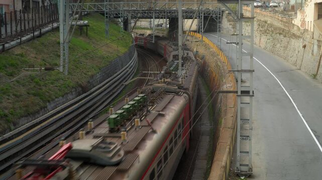 Passenger inter-city train in city near the road