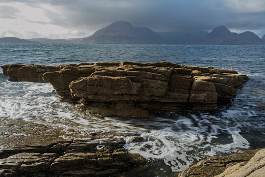 Photograph of Elgol in Scotland showing waves, rocks and mountains