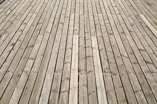 Rustic outdoor timber decking with vertical parallel lines and textured surface detail ideal for architectural and lifestyle concepts.