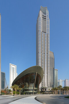 Modern Architecture of Dubai Opera House with Dhow-Inspired Glass Design, Surrounded by Palm Trees and Downtown Skyscrapers under Clear Blue Sky, Dubai, UAE