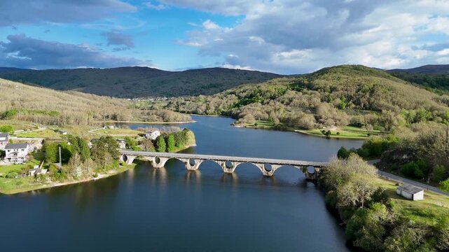 Aerial drone flying over prada reservoir bridge in galicia spain
