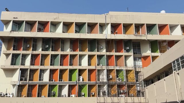 architectural exterior with multicolored window shades and repetitive pattern design