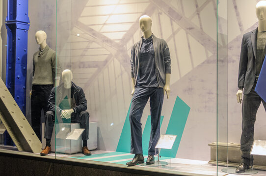 mannequins in a shop window wearing autumn clothes