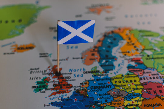 A conceptual close-up of Scotland's flag, The Saltire, on a map, symbolizing themes of national identity, the independence movement, and upcoming elections.