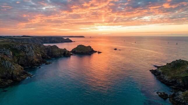 Dramatic Sunset Over Rugged Coastal Cliffs and Turquoise Ocean