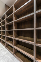 Modern walk in closet with custom wooden shelving system empty wardrobe storage with built in shelves and mirror contemporary interior design luxury dressing room © Viktor Brazhnikow