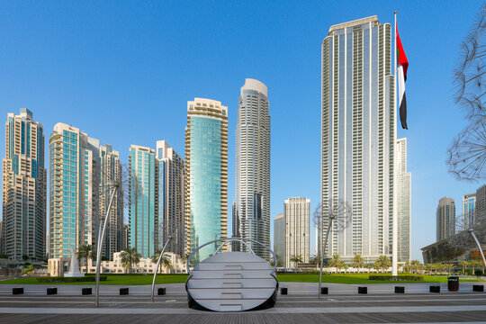 Modern Architecture of Dubai Opera House with Dhow-Inspired Glass Design, Surrounded by Palm Trees and Downtown Skyscrapers under Clear Blue Sky, Dubai, UAE