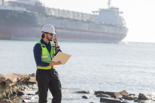 Worker work at a port with a cargo ship in the background