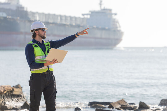 Worker work at a port with a cargo ship in the background