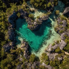 Obraz premium Aerial top view of a stunning heart-shaped turquoise lagoon surrounded by lush tropical forest and rocky limestone cliffs