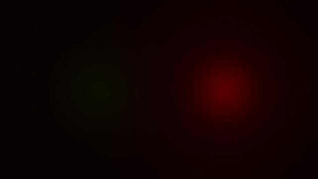 Abstract glowing green and red circular light orbs floating in deep darkness creating a mysterious atmosphere with soft bokeh lens flare effects digital