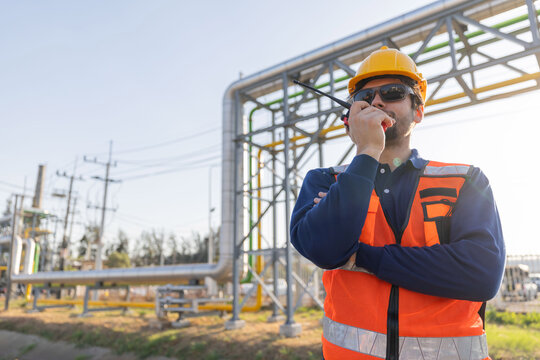 Petroleum engineers with hardhat working at oil refinery site