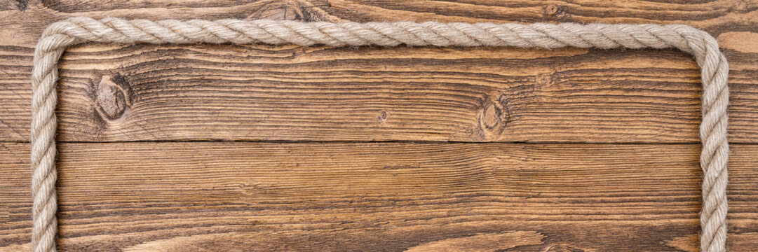 Rustic wooden background with rope frame border horizontal banner copy space