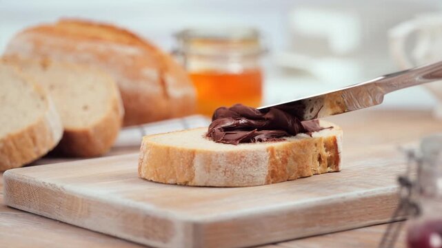 Chocolate spread on fresh bread slice close up homemade sweet breakfast