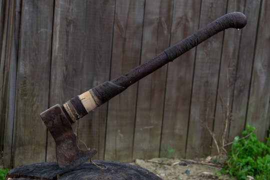 an old axe stuck in a stump