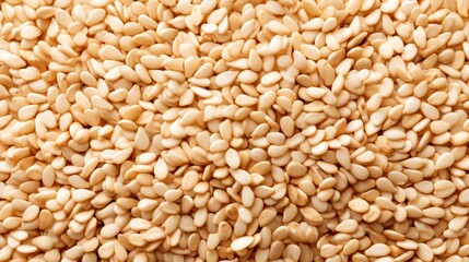 Fototapeta premium Close-Up View of Light Brown Sesame Seeds Spread Evenly on a Surface