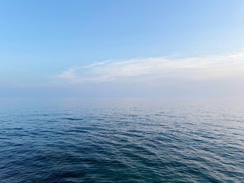 Open sea tranquil blue water and clear sky.