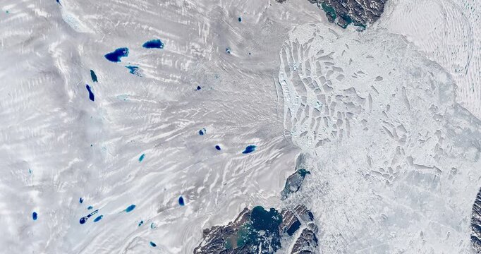 Panoramic top view of glacier flowing into sea, cracking in pieces making icebergs. Camera is moving forward and left. Animation based on image by NASA