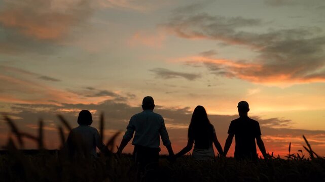 Group farmers teamwork, business group, wheat field harvest, sun. Business people united by one idea. Happy team people holding hands. Teamwork people. Partnership help in business concept. Nature sky