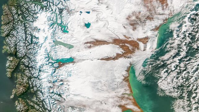 Bird's eye view on glacial area with fjords in Patagonia and cloud formation. Camera is zooming out, rotating clockwise. Animation based on image by NASA