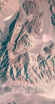 Aerial view on sandy mountains with prints of erosion in desert. Camera is moving forward. Vertical video. Animation based on image by NASA
