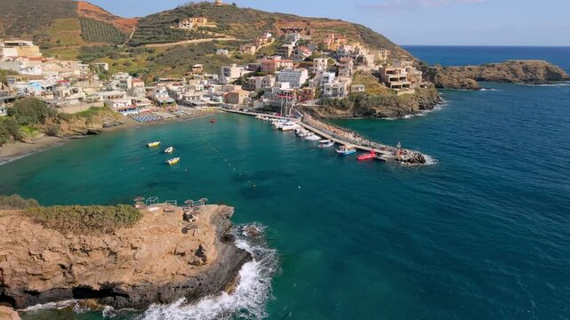2-in-1 aerial: Bali port with boats and Karavostasi beach in Crete, Greece. Close flight over harbor and panoramic view of rugged peninsula and turquoise hidden bay. Scenic coastal landscape, 4k