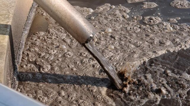 Wastewater Treatment Plant Pipe Pouring Sludge Into Tank