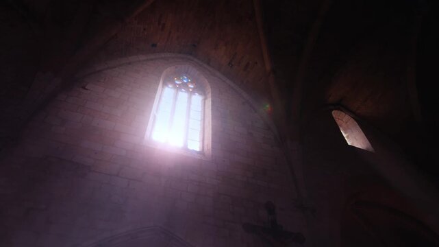 Issigeac Church Stained Glass Window with Dramatic Light Rays