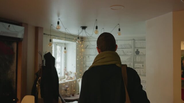 White man entering cozy cafe warm interior with string lights and handdrawn bookshelf wallpaper, winter scarf and leather bag, moves to window seat, rummages through bag, puts on sunglasses,