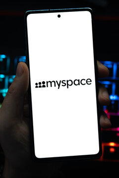 Punta Arenas, Chile &ndash; May 04, 2026: Close-up of a mobile device screen showing the MySpace social networking service logo, held by a user in a dimly lit room with vibrant RGB keyboard lighting