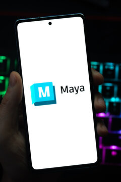 Punta Arenas, Chile &ndash; May 04, 2026: Close-up of a mobile device screen showing the Autodesk Maya software logo, held by a user in a dimly lit room with vibrant RGB keyboard lighting